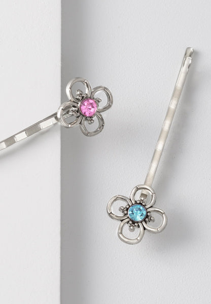 Simple flower bobby pin with a pink or aqua stone center.