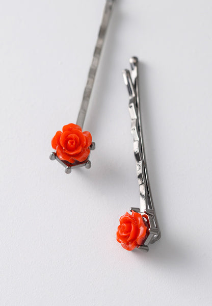 Black nickel plated bobby pin with a scarlet red rose.