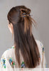 Flexi flip hair clip with denim lapis and imitation rhodium beads in hair.