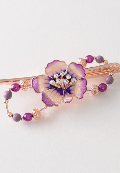 Beautiful rose gold orchid flower flexi hair clip with purple hues and a crystal stone set center. 