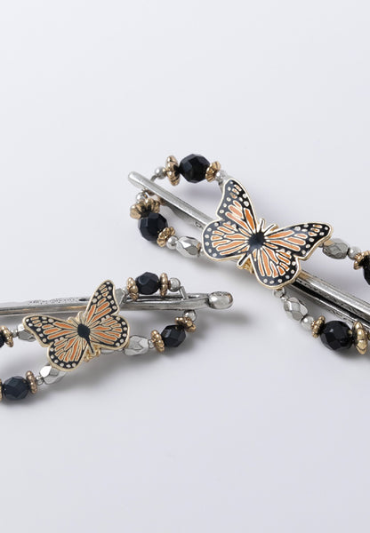 Monarch butterfly flexi hair clip with black and gold accents.