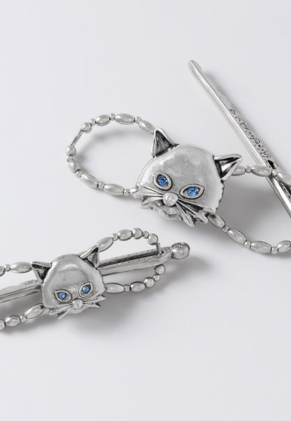 Silver tone cat face flexi hair clip with blue crystal eyes.