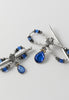 A sapphire teardrop dangled flexi hair clip with blue and silver tone accents.