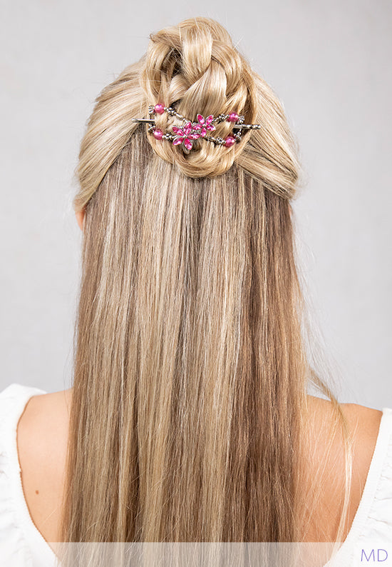 Paisley Flexi shown in hair with bright pink flowers with crystal petals and coordinating hot pink accents. 