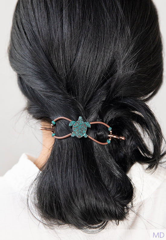 Zippy Flexi shown in hair and features a sea turtle with a swirled shell and patina and brown accents.