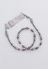 Beaded hairband with shades of plum, deep rose, and slate.
