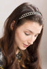 Elegant patterned hairband lined with crystal stone set.
