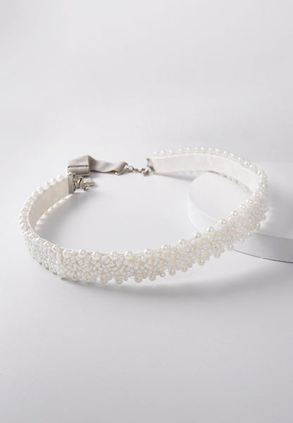 Elegant white pearled hairband on a white band.