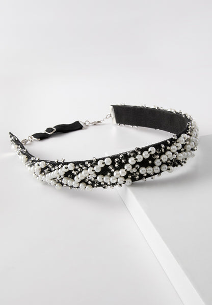 Elegant white pearled hairband on a black band.