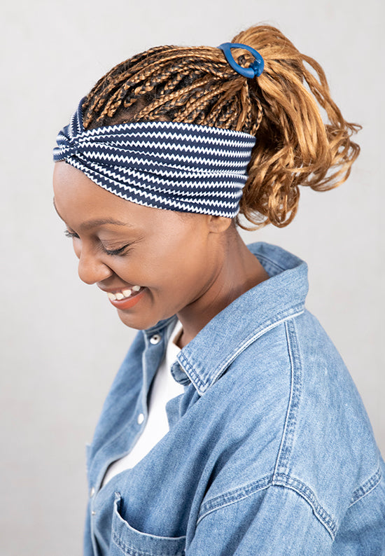 Striped jersey knit hairband shown in hair.