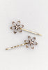 Open flower motif with three aurora borealis stones in this Bobby Pin in goldtone.