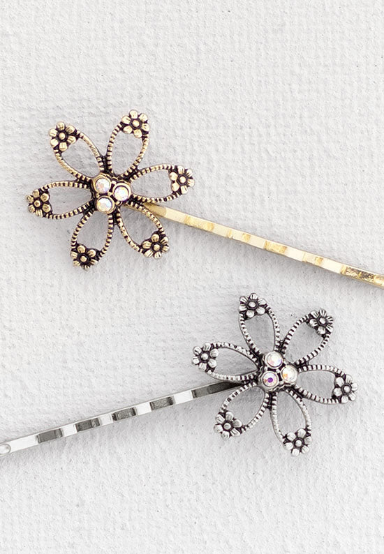 Open flower motif with three aurora borealis stones in this Bobby Pin in goldtone or silvertone.