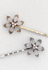 Open flower motif with three aurora borealis stones in this Bobby Pin in goldtone or silvertone.