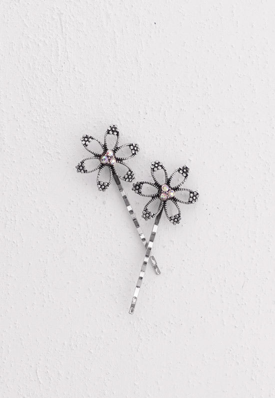Open flower motif with three aurora borealis stones in this Bobby Pin in silvertone.