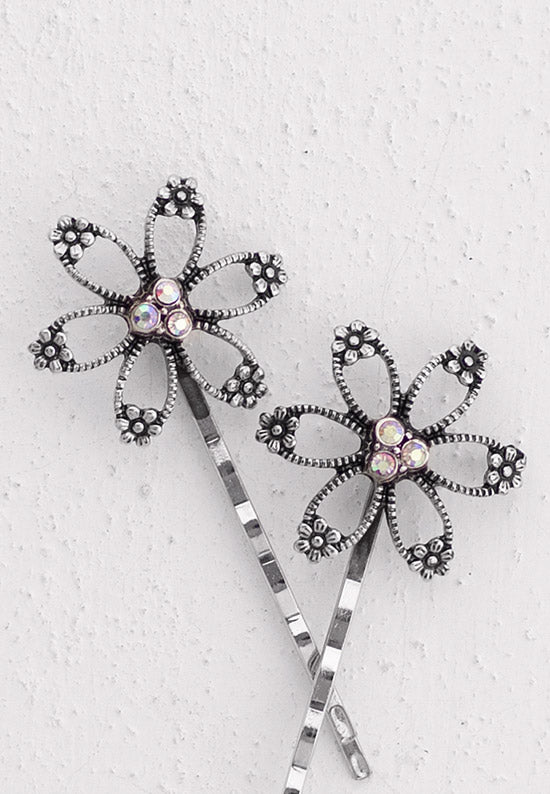 Open flower motif with three aurora borealis stones in this Bobby Pin in silvertone.