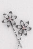 Open flower motif with three aurora borealis stones in this Bobby Pin in silvertone.