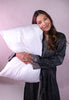 Woman hugging Silk sham encased pillow