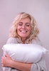 Woman hugging Silk sham encased pillow