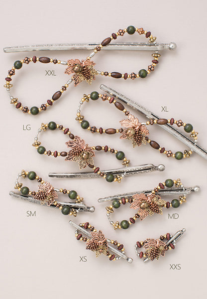 Flexi hair clip with maple leaf with mixed metal drops - pinecone, acorn, and leaf shown in 7 sizes