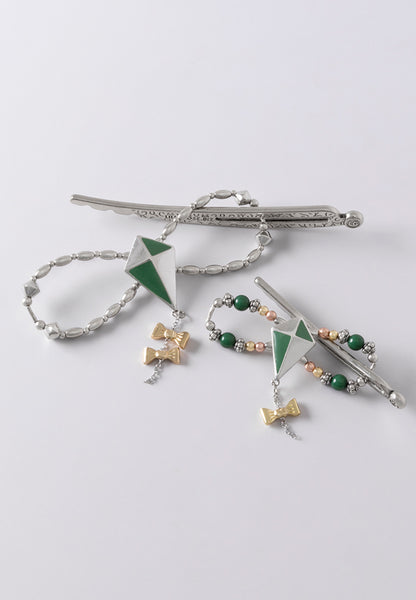 Green and white kite with a brass bow dangle available in two platings.
