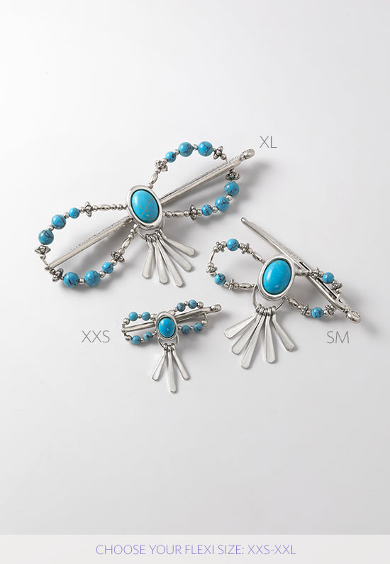Tabitha Flexi Clip features an oval stoneset with paddle drops and natural howlite stone accents. Shown in 3 sizes in turquoise..