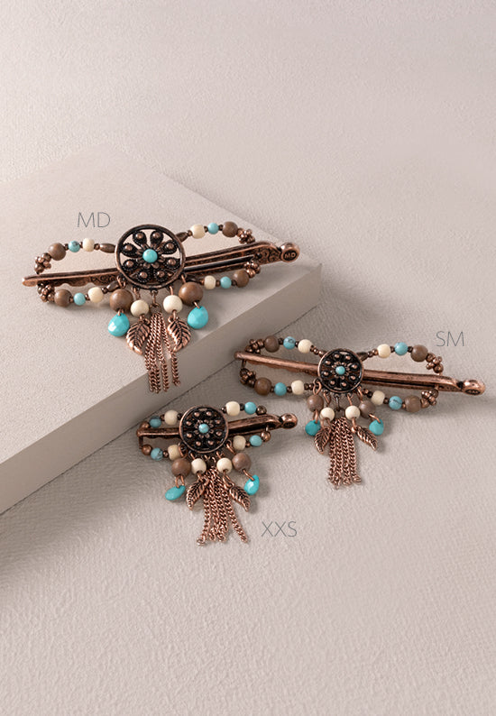 Nicoma Flexi Clip shown in 3 sizes and features a groovy flower round set in burnished coppertone with turquoise, cream and wood accents.