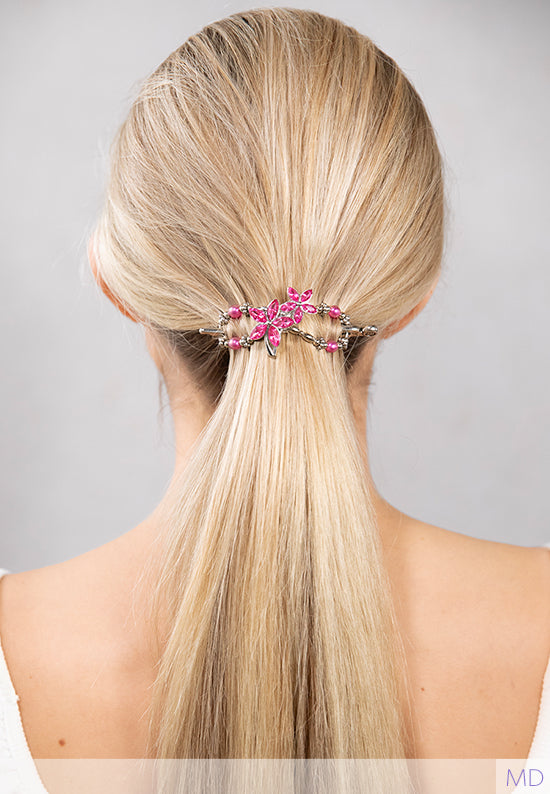 Bright pink flowers with crystal petals and budding pink accents shown in hair.