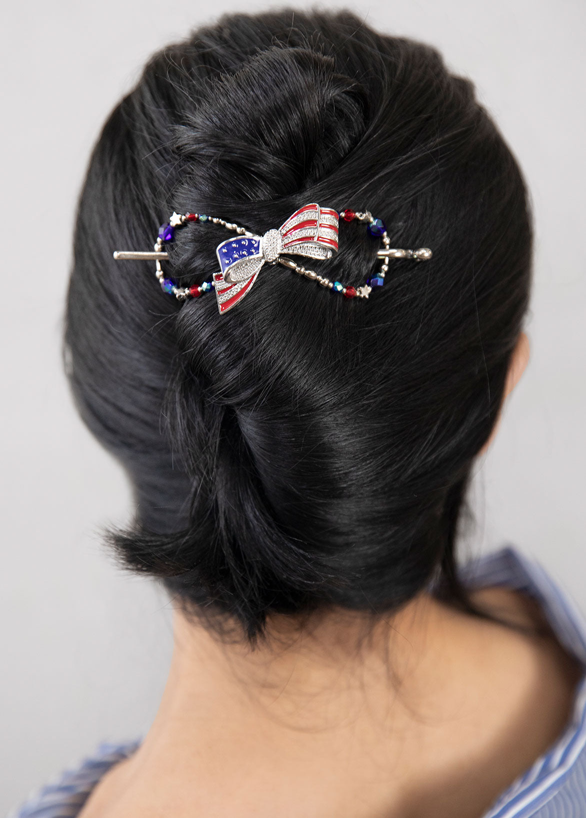 Betsy Flexi Clip features a patriotic bow bursting with bright blue and ruby red colors complemented by star bead accents. 