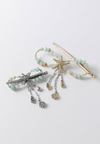 Stella flexi clip available in brasstone and silvertone and features a sea star with seashell dangles and a combination of amazonite stone and glass pearl accents.