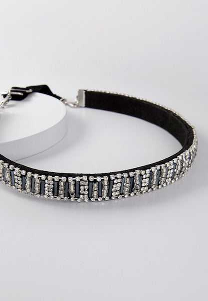 Crystal with hematite and brass seed beads on a black band.