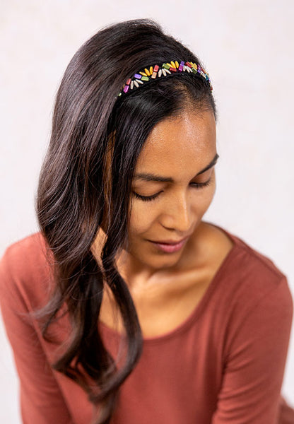 Bright multi-colored metallic beads on a black band.