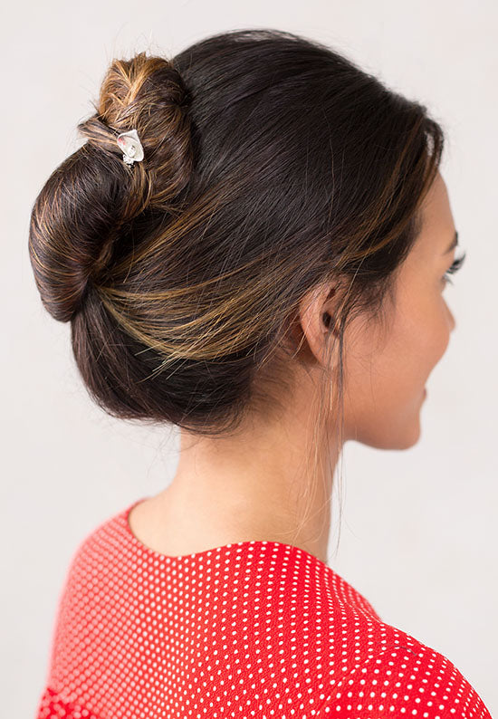 Silver Calla Lily tops a fark wooden stick.