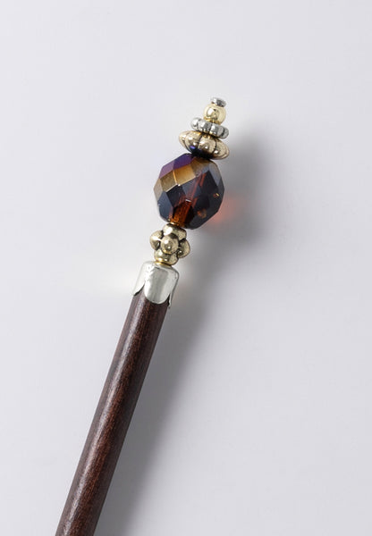 Faceted honey blue iris bead with brasstone accents.