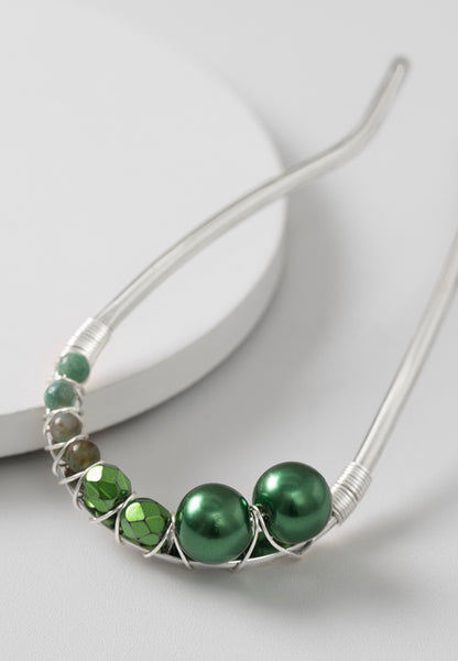 Large-sized U-Pin with a swerve and beautiful green beading in silvertone