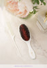 White comb and brush with the Lilla Rose logo.