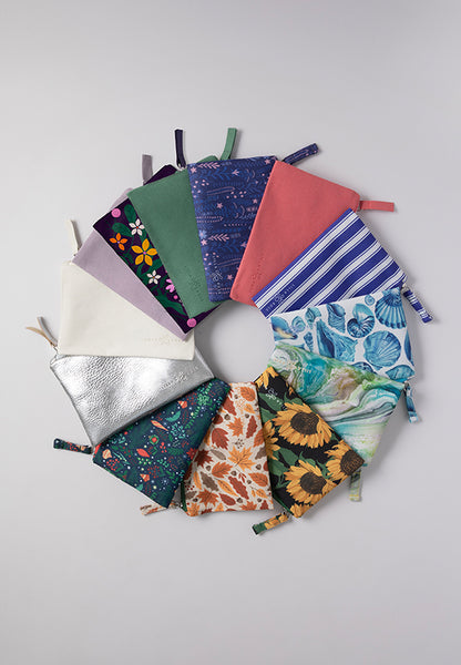 Variety of thirteen different colors and prints of the Mane Event zipper pouch bags. 